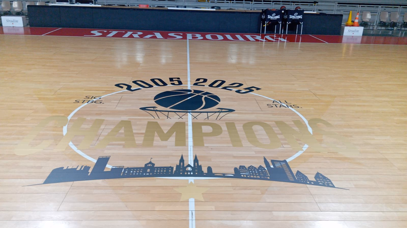 Rond central en marquage de sol repositionnable IND’N’GO® « Champions 2005-2025 » sur le parquet du SIG Strasbourg